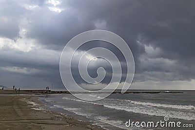 The beach of BenicÃ ssim-BenicÃ¡sim and the Mediterranean Sea joining with rainwater and floods producing a mixture of sediments l Stock Photo